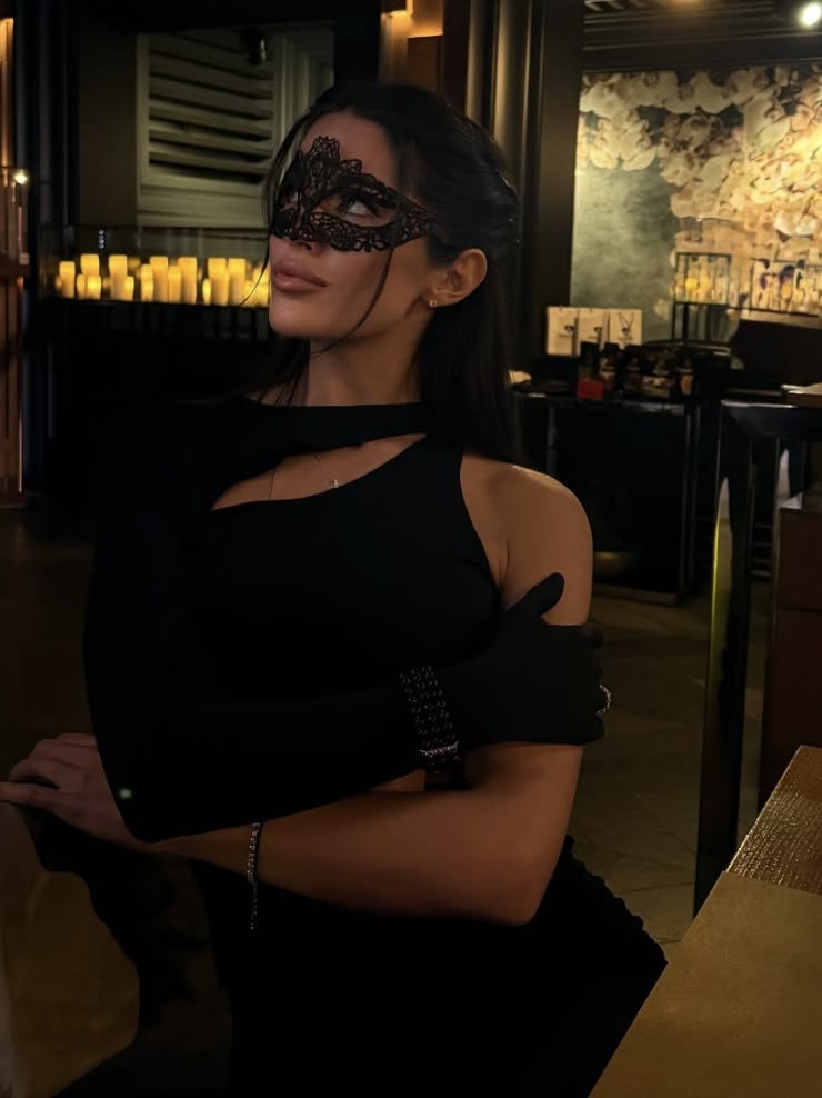 A lace mask at the bar by candlelight