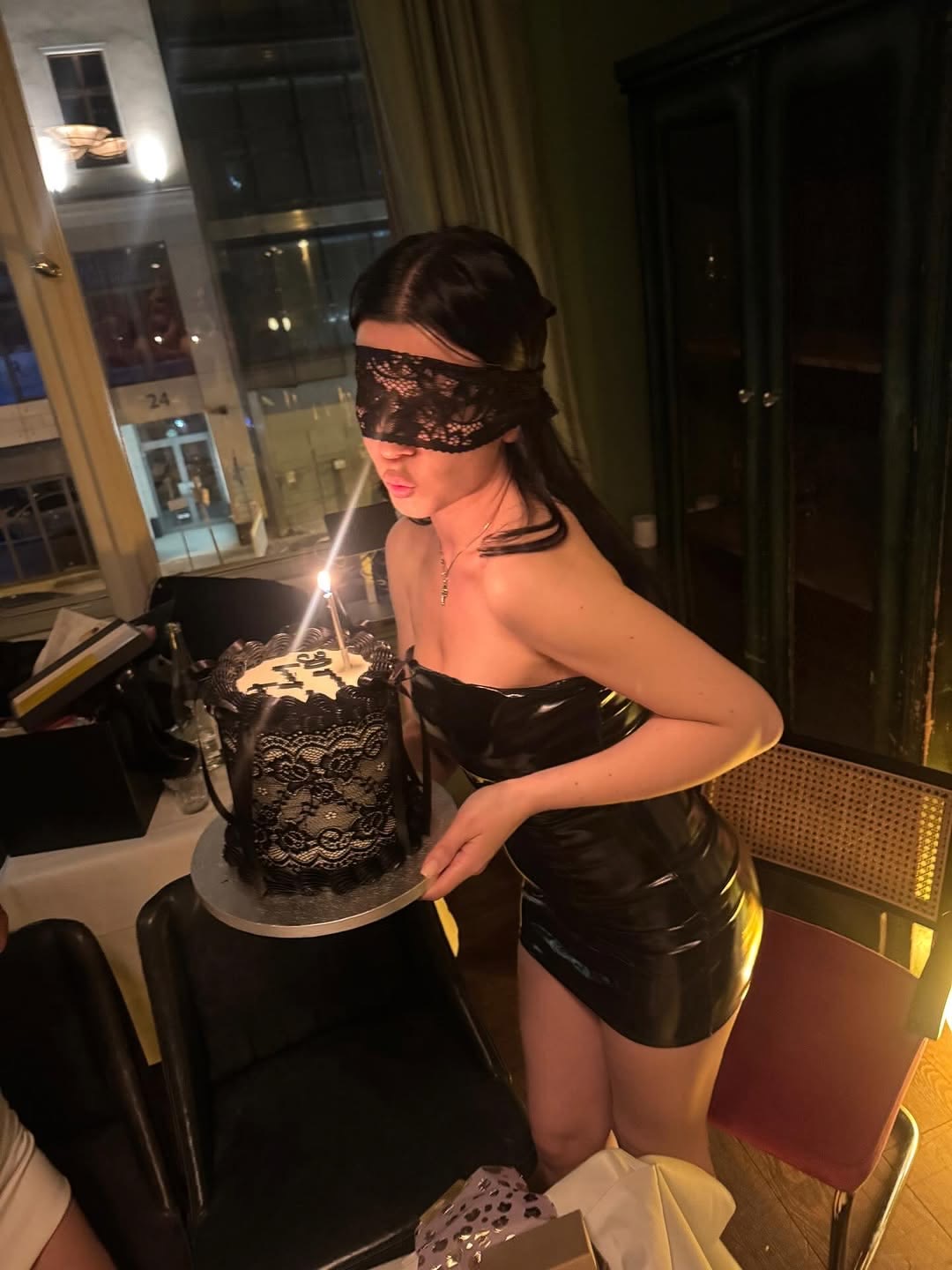 A birthday candle behind a lace blindfold