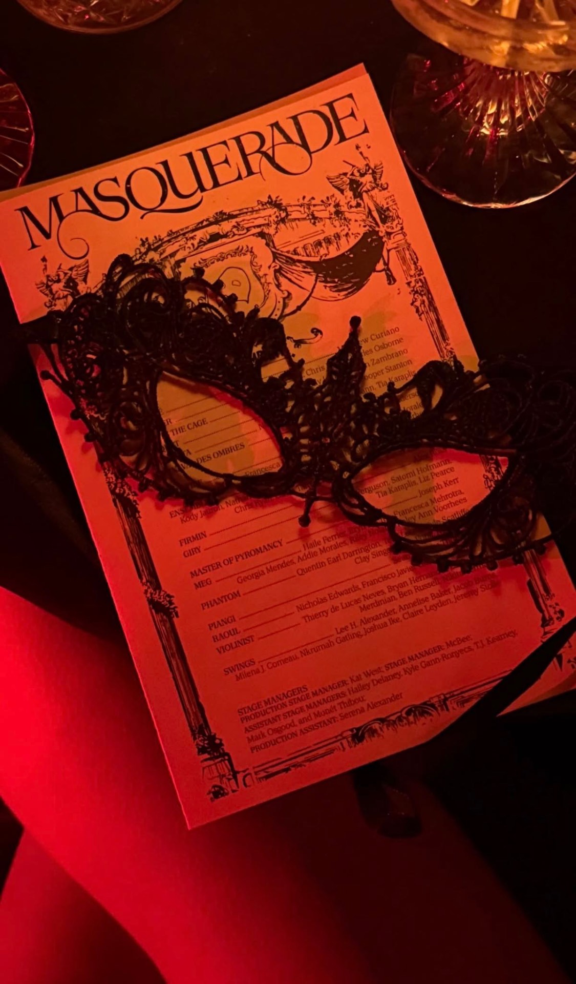 A masquerade mask over the evening program